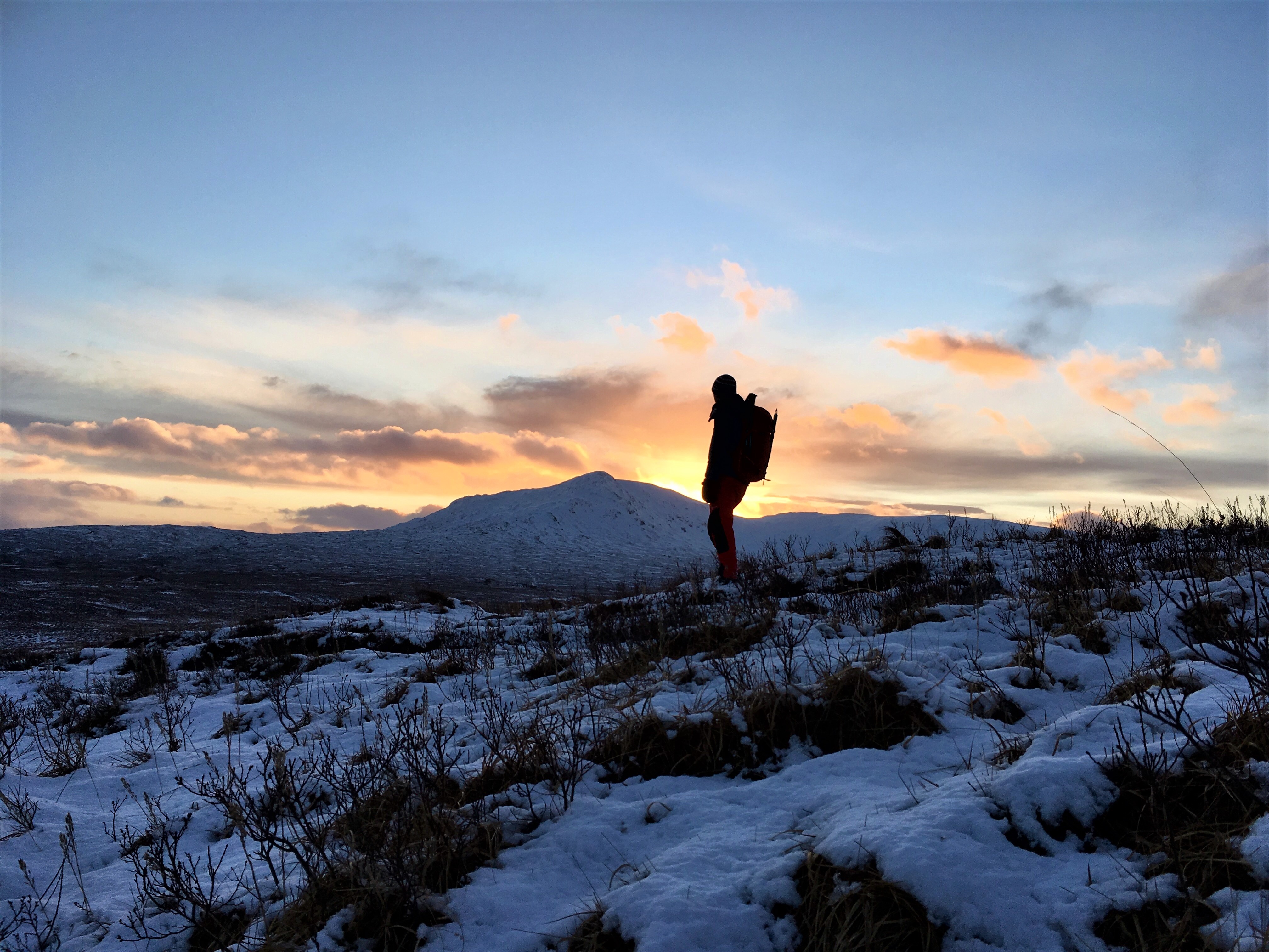 Sunset over snowy peaks.