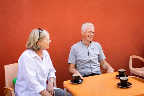 man and woman enjoying coffee at cafe