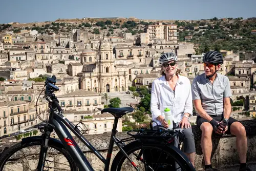 Man and Woman biking in Italy