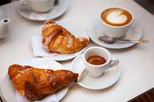 coffee and croissants on table