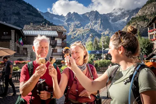 Three people enjoy ice cream with Mont Blanc in background